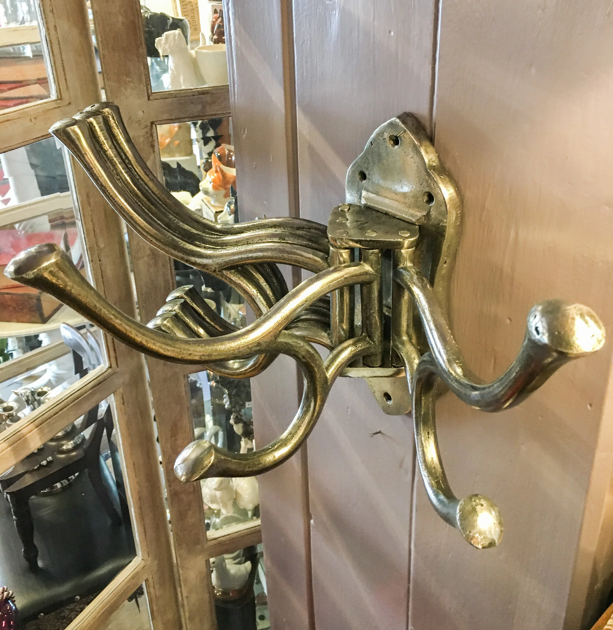 A vintage style revolving 5 multi hooks coat hanger in polished metal